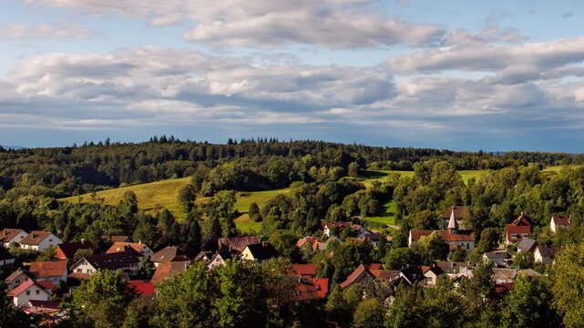 4K UHD Time-lapse of Clouds Moving Over a Scenic Rural Village