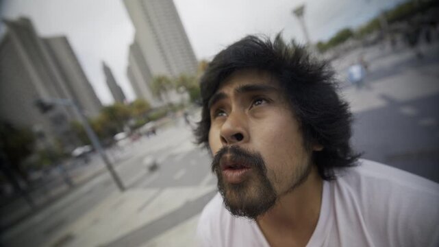 Young Man Looking Up At Sky And Closing Eyes As He focuses - Close-Up In San Francisco