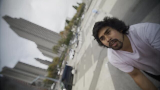 Man Staring At Tall Board And Focusing In San Francisco Plaza - Slow Motion Steady Cam Closeup
