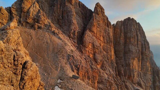Aerial drone view of a beautiful sunrise over the majestic Dolomite Mountains. Golden morning light. Breathtaking sunrise over the Alpine landscape.	
