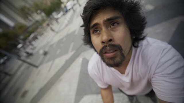 Bearded Man On Concrete Steps In San Francisco Plaza Staring Up With Passion In Eyes - Closeup