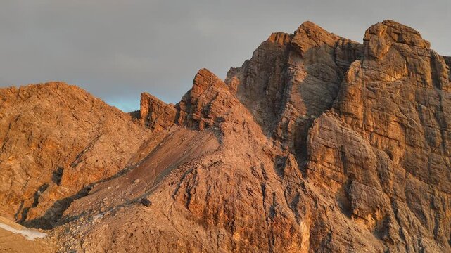 Aerial drone view of a beautiful sunrise over the majestic Dolomite Mountains. Golden morning light. Breathtaking sunrise over the Alpine landscape.	
