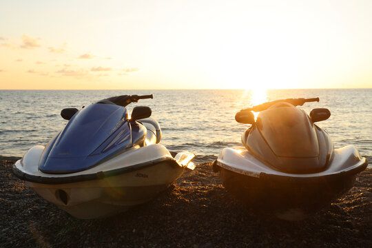 Batumi, Georgia - June 2, 2023: honda dohc 4 stroke aquatrax two jet ski boats on coast in front of sea ocean water waves at the sunset. Extreme summer sport power action, fast racing holiday vacation