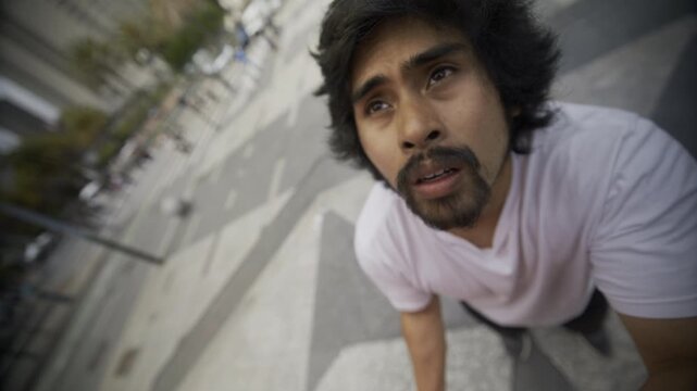 Man on Concrete Steps Staring Up With Passionate Look - Closeup