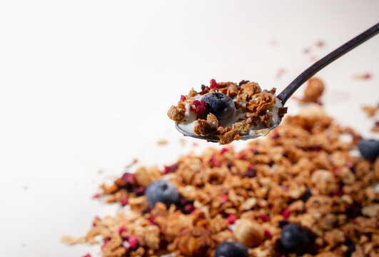 Healthy Granola Yogurt Parfait with Fresh Strawberry, Mint and Coconut Flakes on Pink Background