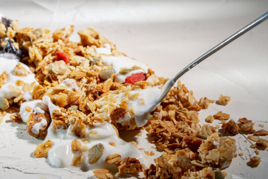 Crunchy Granola with Yogurt on Spoon, Healthy Breakfast Close Up