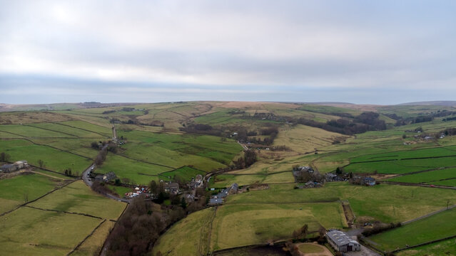 High aerial view of the top of Colden valley and the hamlet of Colden close to the village of Heptonstall near Hebden Bridge, panoramic winter landscape showing farms and fields