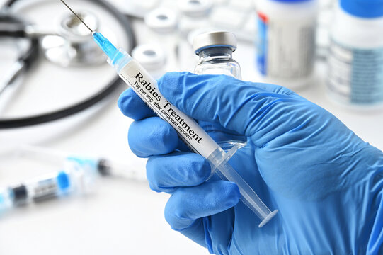 Rabies treatment vaccine shot - hand holding syringe