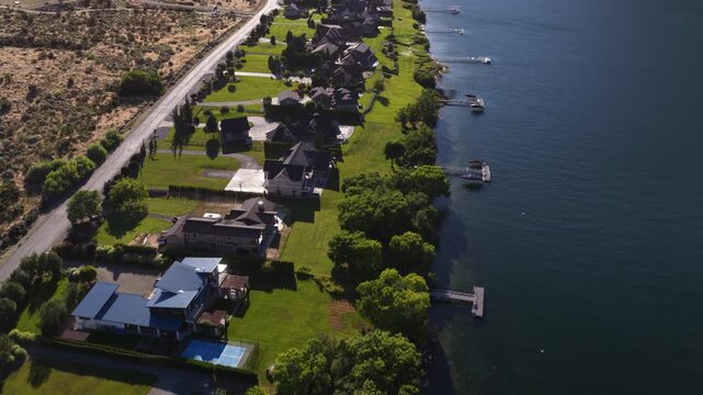 Aerial of residential waterfront community on Columbia River Stayman Washington with houses set along the waters edge with private docks