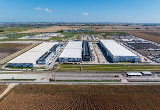 Aerial view of a large data center campus in Hutto, Texas, with three massive buildings with 400M square feet of space and 600MW power capacity