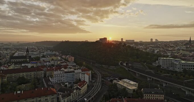 Prague Czechia Aerial v127 cinematic drone flyover Florenc across V&iacute;tkov hill capturing National Memorial and Zizkov cityscape against beautiful sunrise views - Shot with Mavic 3 Cine - November 2022