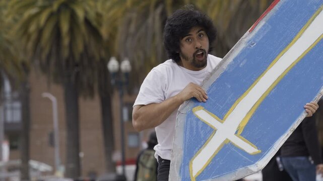 Man Doing Awesome Tricks With Blue Cross Board In San Francisco Plaza - Slow Motion Medium Shot