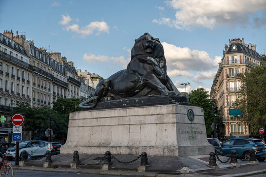 The iconic Lion of Belfort bronze statue by Auguste Bartholdi at Place Denfert-Rochereau in Paris, France, a monumental tribute to the defense of the city during the Franco-Prussian War