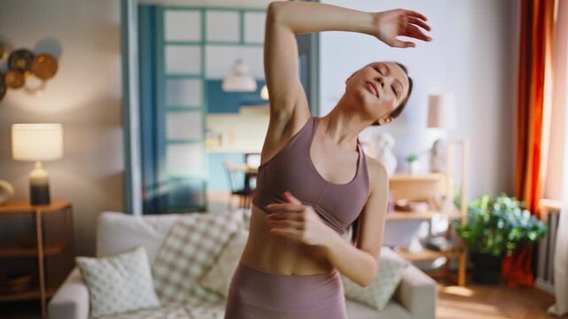 Asian woman stretching side bend home living room. Fit girl morning yoga