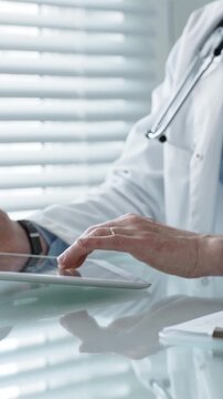 Healthcare professional wearing a lab coat and stethoscope, using a tablet and laptop, collaborating with technology for medical research, digital records, and remote patient care