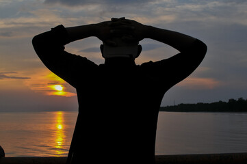 Fototapeta premium Silhoette man at beach at sunset