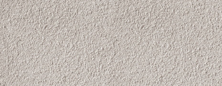 Rough beige stucco wall surface texture background