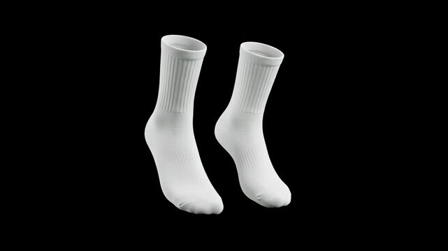 A professional product shot of a pair of blank white cotton crew socks standing upright against a solid black studio background. This clean, high-contrast apparel asset is designed for clothing retail