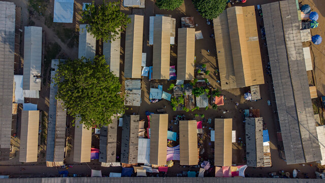 Aerial view of Keta Market Road 3 with rows of market stalls featuring corrugated metal roofs, trees, and pathways in Keta, Volta Region, Ghana.