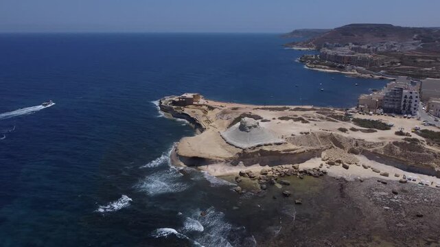 Xwejni s centuries-old salt pans unfold along the rugged coast of Zebbug, Gozo, geometric pools and vivid Mediterranean blues in a sweeping summer Aerial view. High quality 4k footage