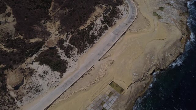 Xwejni s centuries-old salt pans unfold along the rugged coast of Zebbug, Gozo, geometric pools and vivid Mediterranean blues in a sweeping summer Aerial view. High quality 4k footage