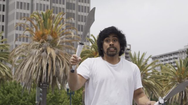 Juggler Tossing And Juggling Knives Overhead In San Francisco Plaza - Slow Motion