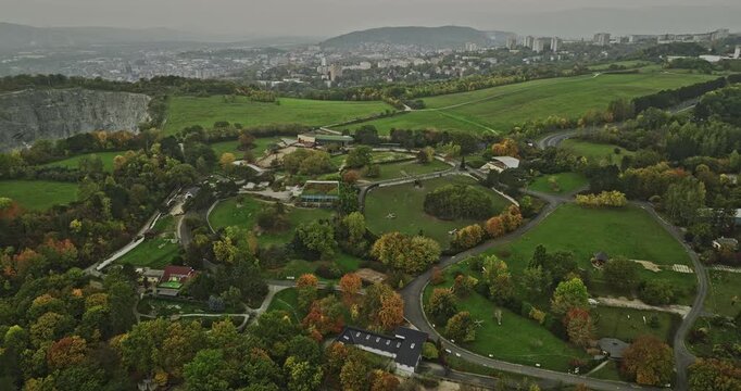 Usti nad Labem Czechia Aerial v5 panoramic panning view, drone flyover hillside zoo capturing industrial area by the bank of Elbe river and massive quarry site - Shot with Mavic 3 Cine - November 2022