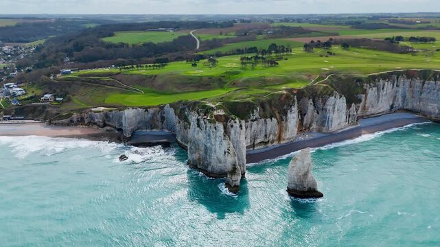 Aerial view of Etretat cliffs and English Channel coast, France. Natural limestone arch, rocky shoreline and sea landscape in Normandy