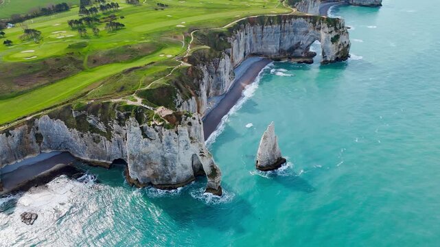 Normandy coastal cliffs with chalk geology, cliff erosion and natural arch carved by sea over time. Drone view