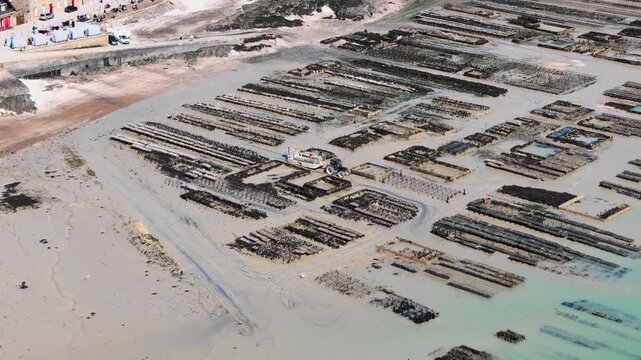 Oyster beds and shallow coastal water at low tide in Cancale, France, highlighting tidal aquaculture patterns