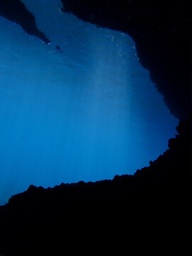 Cathedrals of light. Underwater photo of a dreamlike and etheral environment. From cave scuba dive in rays of sunlight. Unspecified.