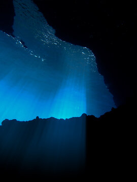 Cathedrals of light. Underwater photo of a dreamlike and etheral environment. From cave scuba dive in rays of sunlight. Unspecified.