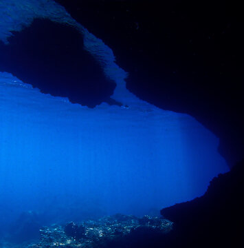 Cathedrals of light. Underwater photo of a dreamlike and etheral environment. From cave scuba dive in rays of sunlight. Unspecified.