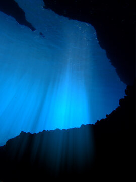 Cathedrals of light. Underwater photo of a dreamlike and etheral environment. From cave scuba dive in rays of sunlight. Unspecified.