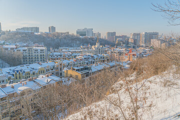 Winter scene of Kiev, Ukraine cityscape from a high vantage point Snow-dusted houses and buildings with varied architecture, contrasting snow-covered landscape, bare trees with fresh snow, early mor © Mister