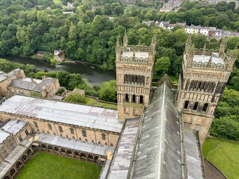 Top Down View of Cathedral Tower: A top-down perspective captures a grand rectangular cathedral tower with intricate masonry details on all sides, looking down onto a manicured green lawn.