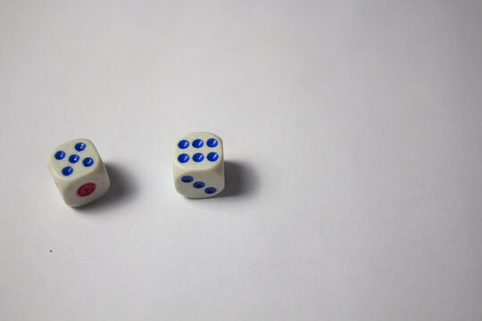 Two white dice showing numbers five and six on a clean white background