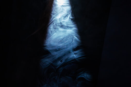 Dimly lit room with smoke, cool color scheme blue dominating, mysterious atmosphere, door or opening with light, impressionistic style, wave-like smoke patterns, skewed perspective