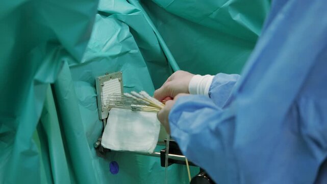 surgeon holding surgical instruments in surgery