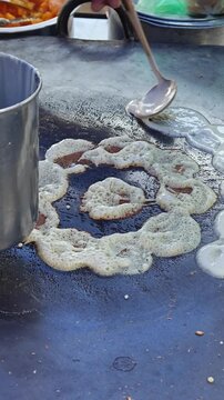 Street Vendor Preparing Traditional Kuih Manja Using Wheat Flour and Sweet Potato Starch at a Motorcycle Stall