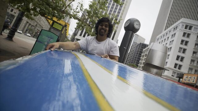 Man Smiling As he spins It Around In Downtown San Francisco - POV From Board
