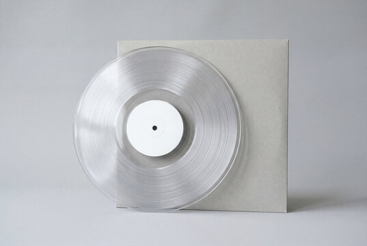 Clear transparent vinyl record leaning on a grey sleeve