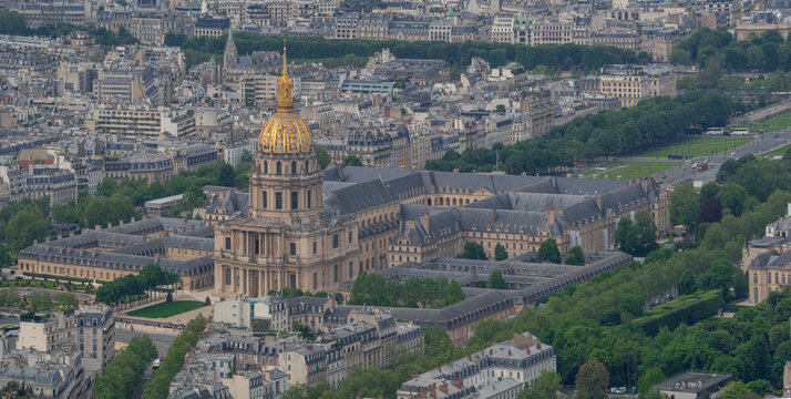 Aerial view of Les Invalides with its iconic golden dome surrounded by historic buildings and lush green gardens in Paris, Ile-de-France, France.