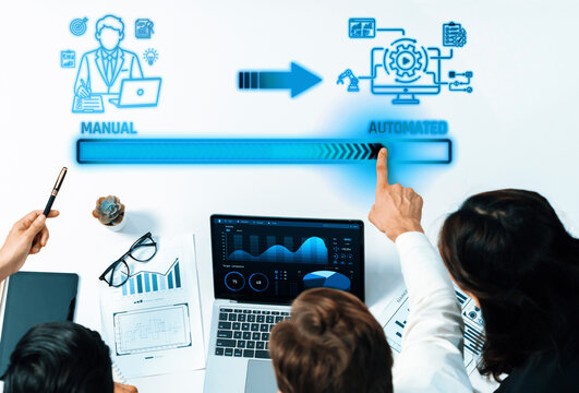 Business team transition from manual processes to automated solutions with hands pointing at digital graphs and blue arrows representing progress. Liminal.