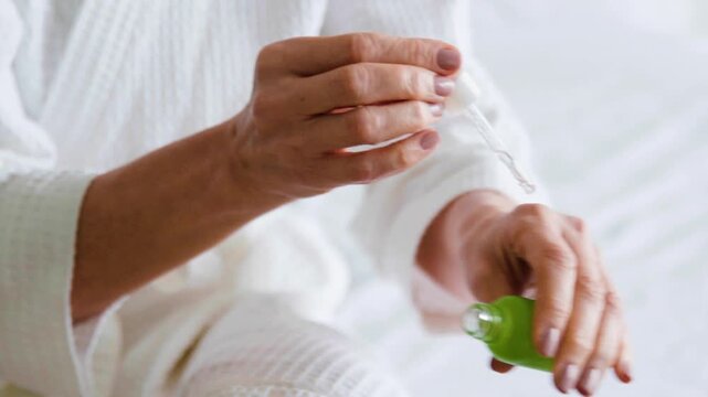senior woman holding pills in her hand