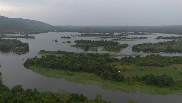 Aerial view of the Volta River near The Royal Senchi Resort with lush green islands, calm water, and dense vegetation in Asuogyaman, Eastern Region, Ghana.