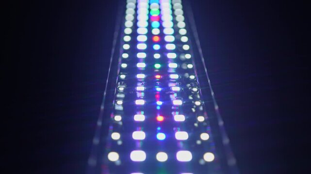 Led light emitting diode light. Semiconductor device produces visible light while has longevity and energy savings. RGB led light panel with diodes flashing colours.