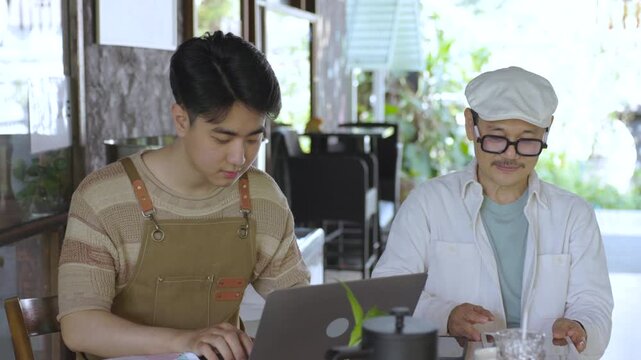 Modern family small business digital management, senior cafe owner guiding young barista worker or son sharing experience teamwork learning growth trust technology management lifestyle in coffee shop