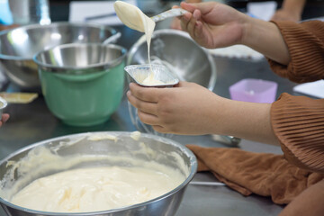 Fototapeta premium Woman baking in the kitchen