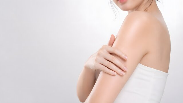 Asian Woman Body Skincare Portrait Touching Smooth Upper Arm With White Top And Clean Copy Space